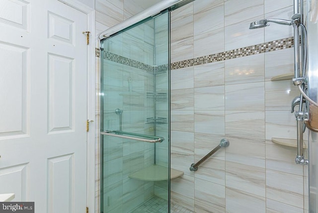 bathroom with a shower with shower door