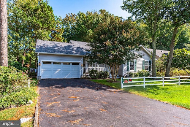 ranch-style house with a garage and a front yard