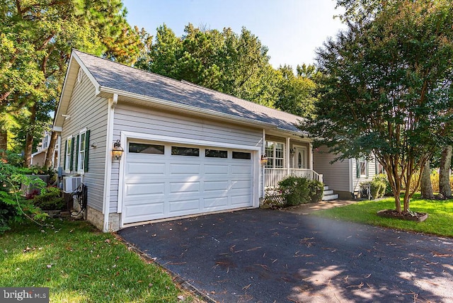 single story home featuring a garage and a front lawn