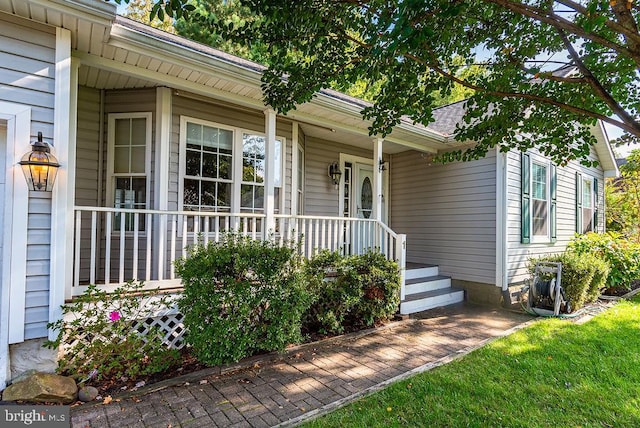 view of exterior entry featuring a porch