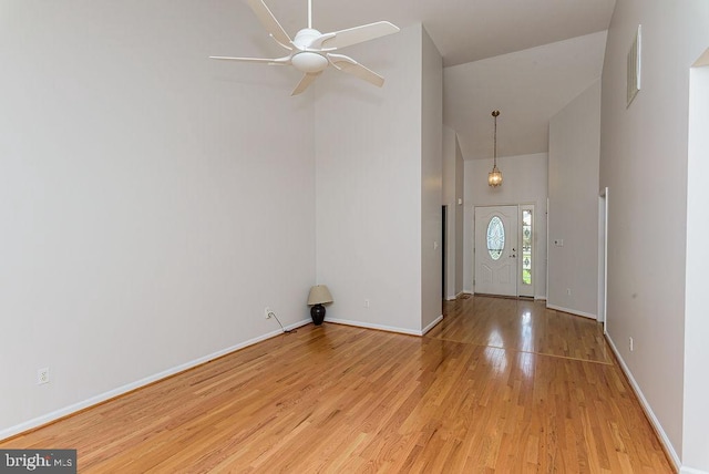 entryway with ceiling fan, light hardwood / wood-style flooring, and high vaulted ceiling