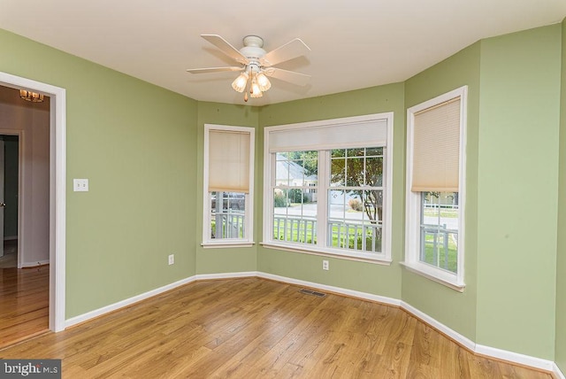 spare room with light hardwood / wood-style floors and ceiling fan