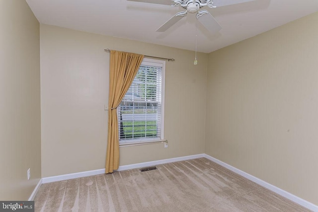 empty room featuring ceiling fan and light colored carpet