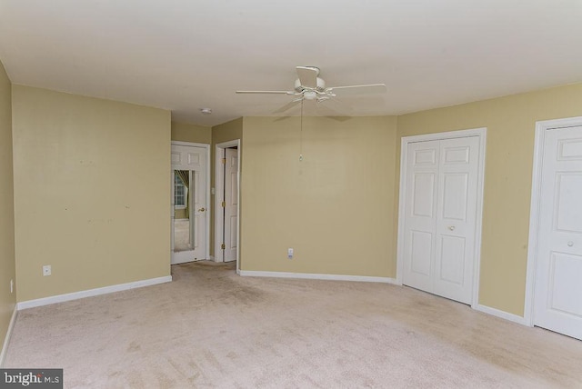 carpeted empty room featuring ceiling fan