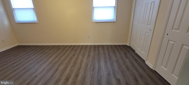 unfurnished bedroom with dark hardwood / wood-style flooring