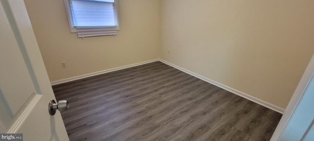 empty room with dark hardwood / wood-style flooring