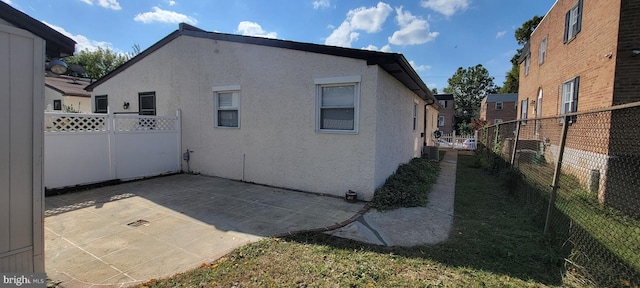 view of property exterior with a patio