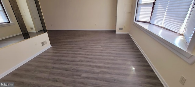 empty room with dark wood-type flooring