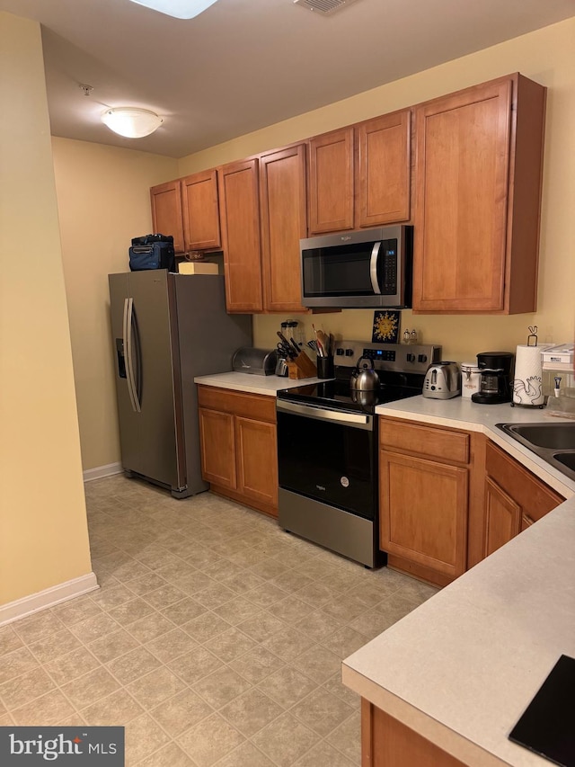 kitchen with sink and appliances with stainless steel finishes