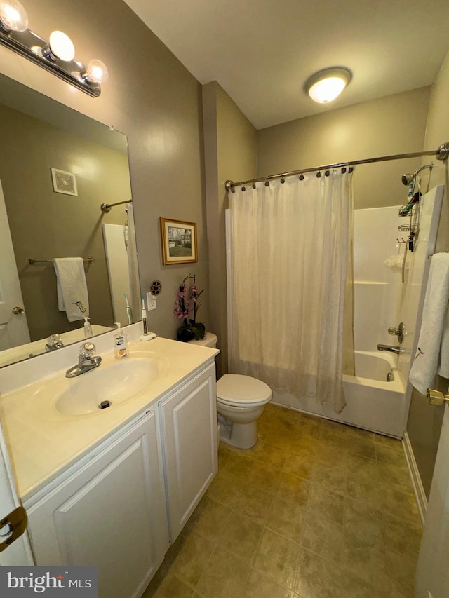 full bathroom with toilet, vanity, and shower / tub combo with curtain