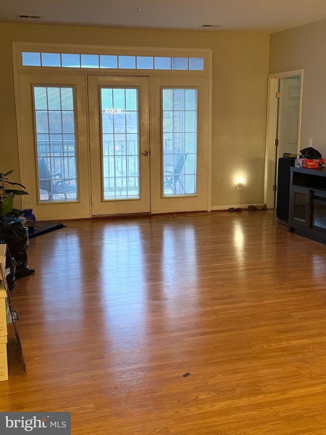 living room featuring light hardwood / wood-style flooring and french doors