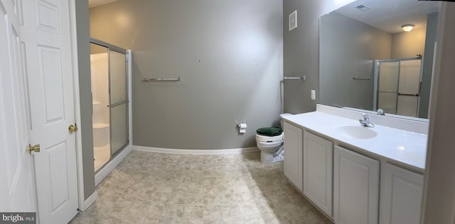 bathroom featuring tile patterned flooring, toilet, vanity, and walk in shower