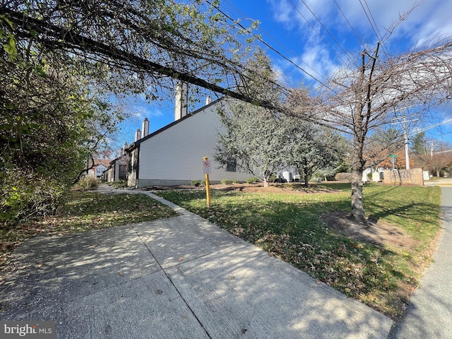 view of side of property with a yard