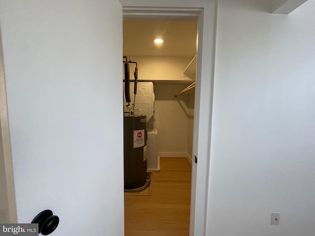 walk in closet featuring wood-type flooring and water heater