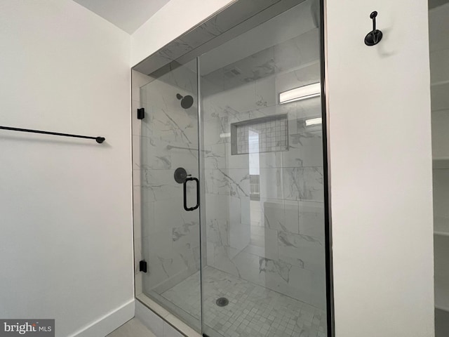 bathroom with a shower with shower door