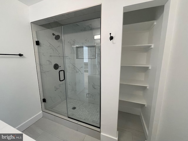 bathroom featuring tile patterned floors and a shower with door