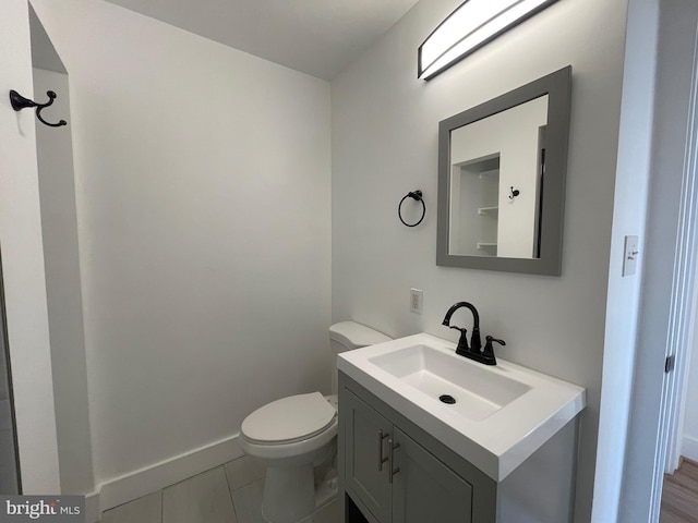 bathroom featuring tile patterned floors, vanity, and toilet