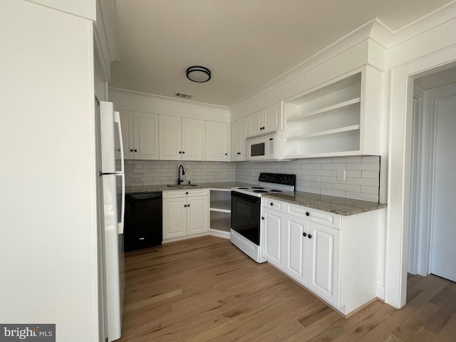 kitchen featuring white cabinetry, sink, white appliances, and light hardwood / wood-style flooring