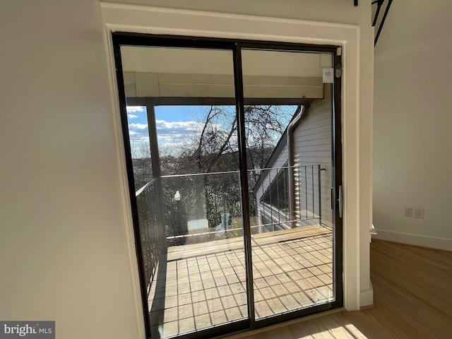 doorway to outside with hardwood / wood-style flooring