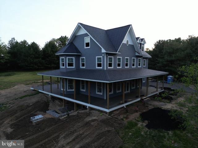 rear view of house featuring a porch