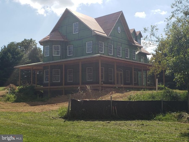 rear view of property with a yard