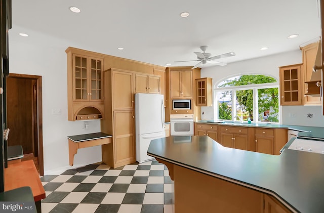 kitchen with sink, white appliances, and ceiling fan