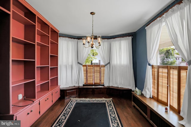 mudroom featuring a healthy amount of sunlight, ornamental molding, an inviting chandelier, and dark hardwood / wood-style floors