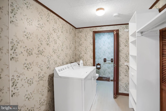 clothes washing area featuring ornamental molding, a textured ceiling, and washing machine and clothes dryer