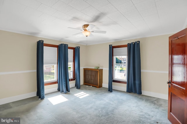 carpeted empty room featuring ceiling fan