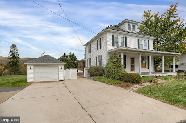 view of front of home featuring a front yard, an outdoor structure, a garage, and a porch