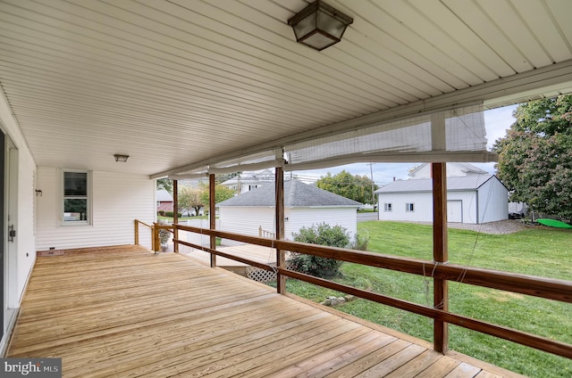 wooden deck featuring a shed and a yard