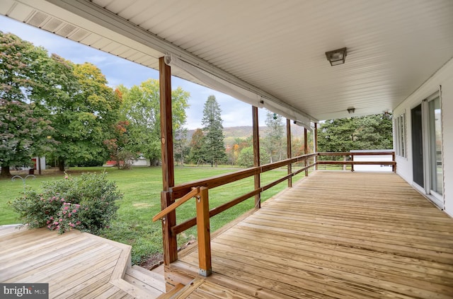 wooden deck featuring a yard