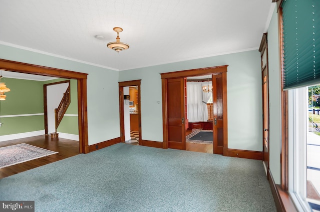 spare room featuring crown molding and dark wood-type flooring