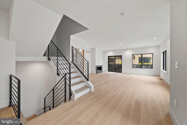 706 Latona St Unit J, Philadelphia, PA 19147 - unfurnished living room featuring wood finished floors, baseboards, stairs, and recessed lighting