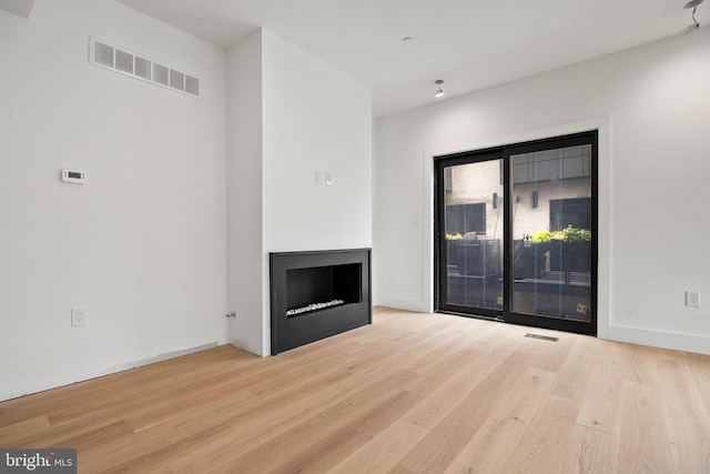 706 Latona St Unit J, Philadelphia, PA 19147 - unfurnished living room with a fireplace and wood finished floors