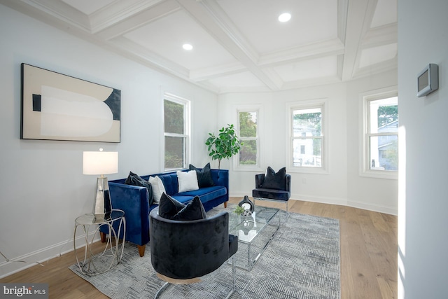 living area with coffered ceiling, beamed ceiling, hardwood / wood-style flooring, and crown molding