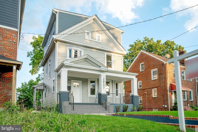 front of property with a front yard and covered porch