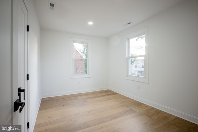 spare room featuring light wood-type flooring