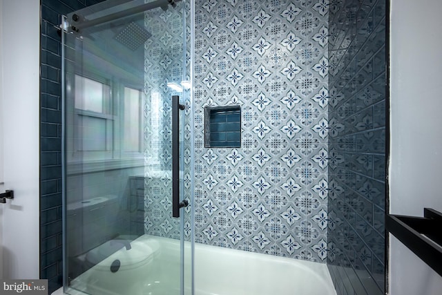 bathroom featuring vanity and enclosed tub / shower combo