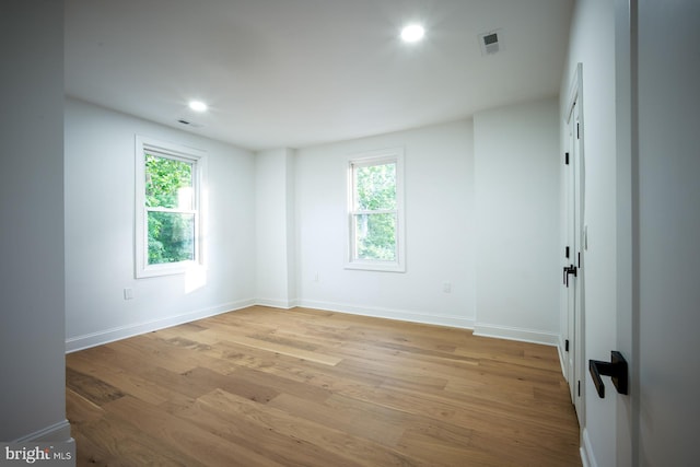 spare room with light hardwood / wood-style floors