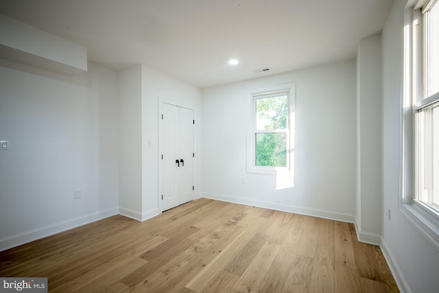 unfurnished room with light hardwood / wood-style floors