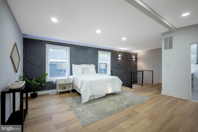 bedroom featuring light hardwood / wood-style flooring and multiple windows