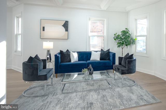 living room featuring coffered ceiling, beamed ceiling, plenty of natural light, and hardwood / wood-style floors