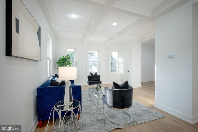 living area featuring beamed ceiling, coffered ceiling, hardwood / wood-style floors, and crown molding