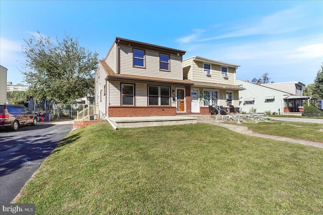 view of front of property with covered porch and a front lawn