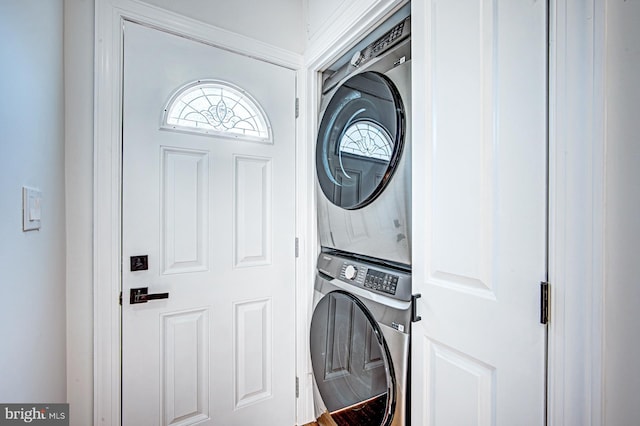 clothes washing area featuring stacked washer / dryer