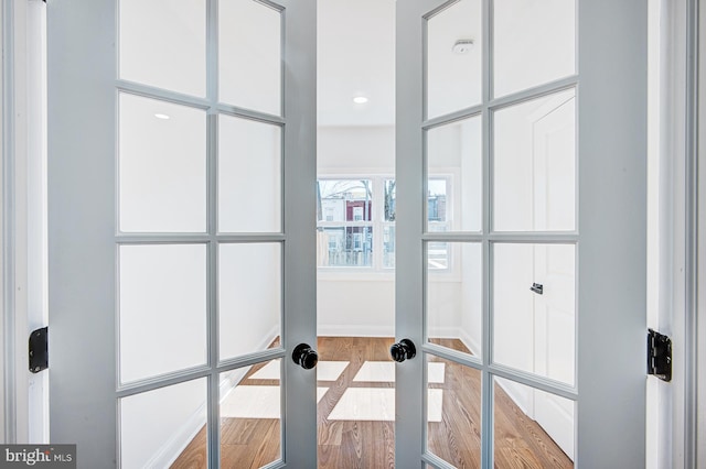 room details with french doors and hardwood / wood-style floors