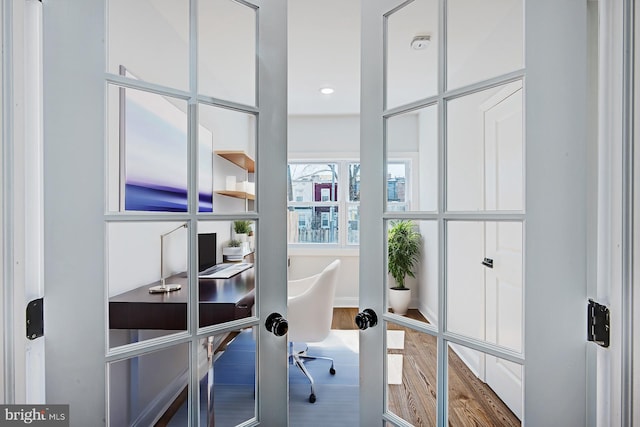 office featuring french doors and hardwood / wood-style flooring