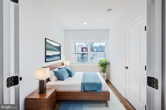 bedroom with wood-type flooring