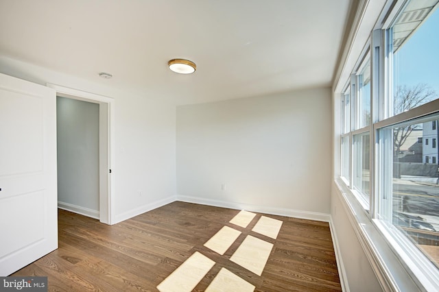 spare room with dark hardwood / wood-style flooring